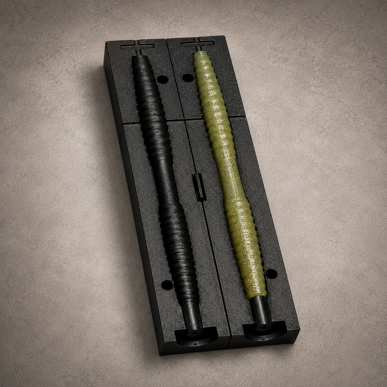 3D-printed two-part mold with a poured stick bait demolded next to it